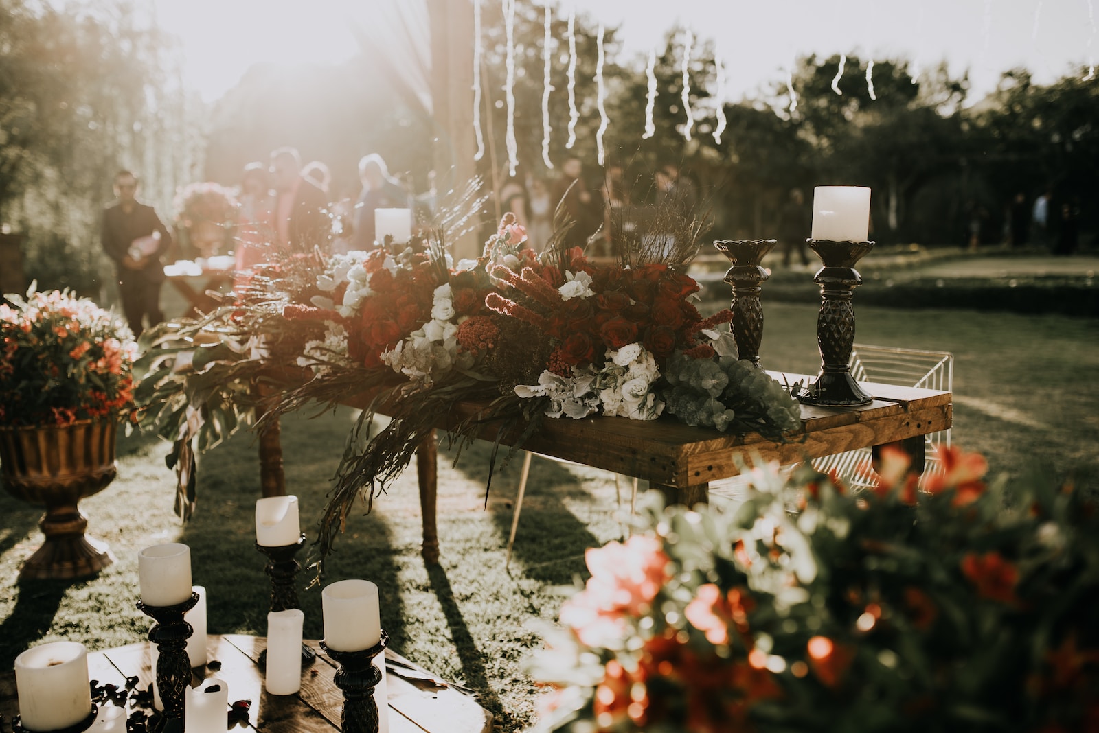 assorted-color flower decors on table with candle holders