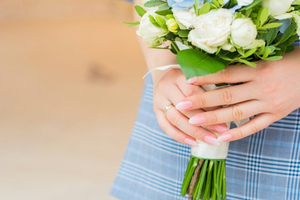 photo of woman holding white flowers