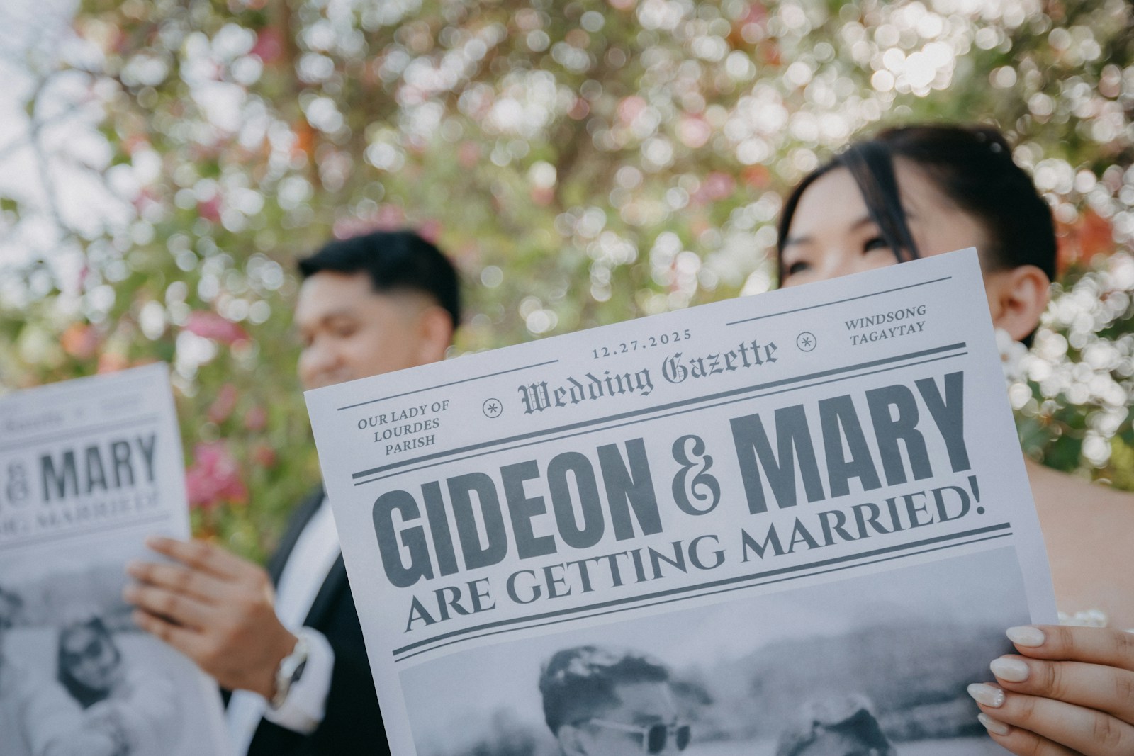 Couple holding newspaper announcing their marriage.
