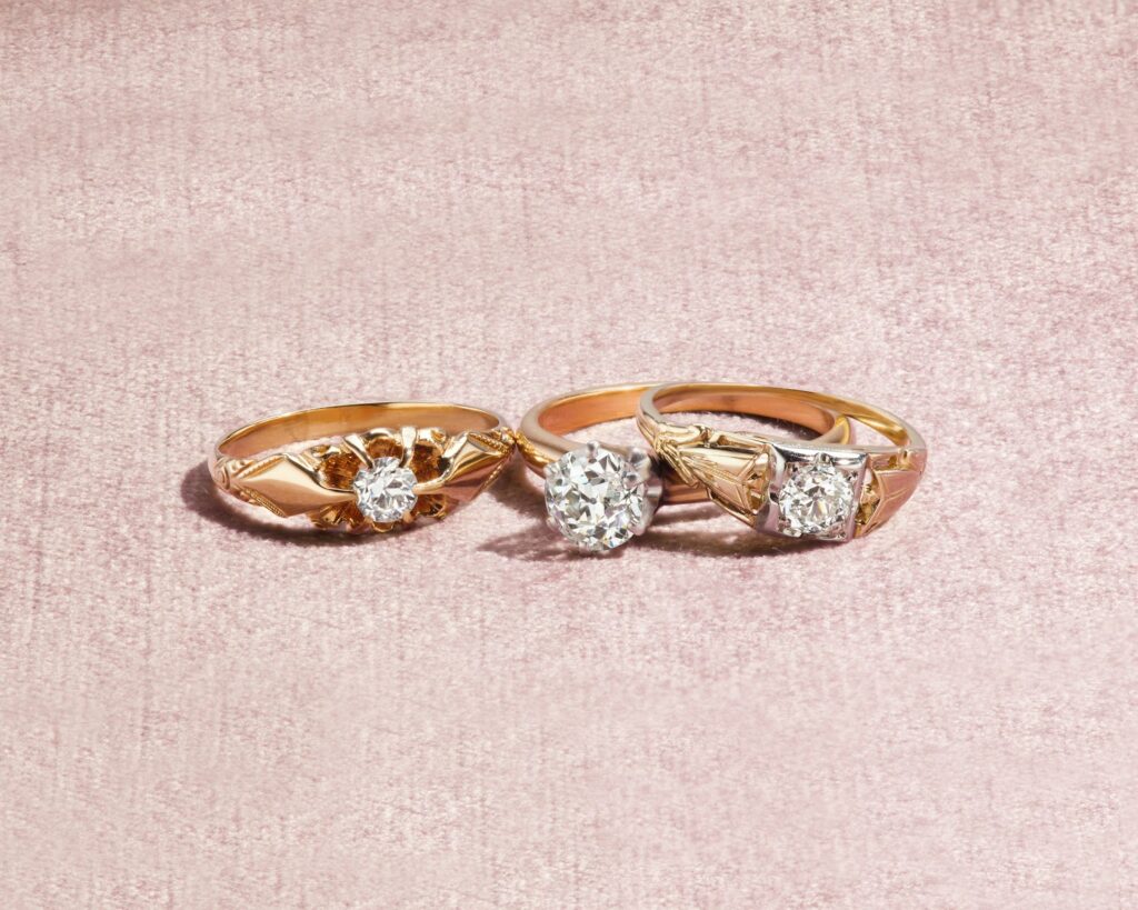 silver and diamond ring on white textile