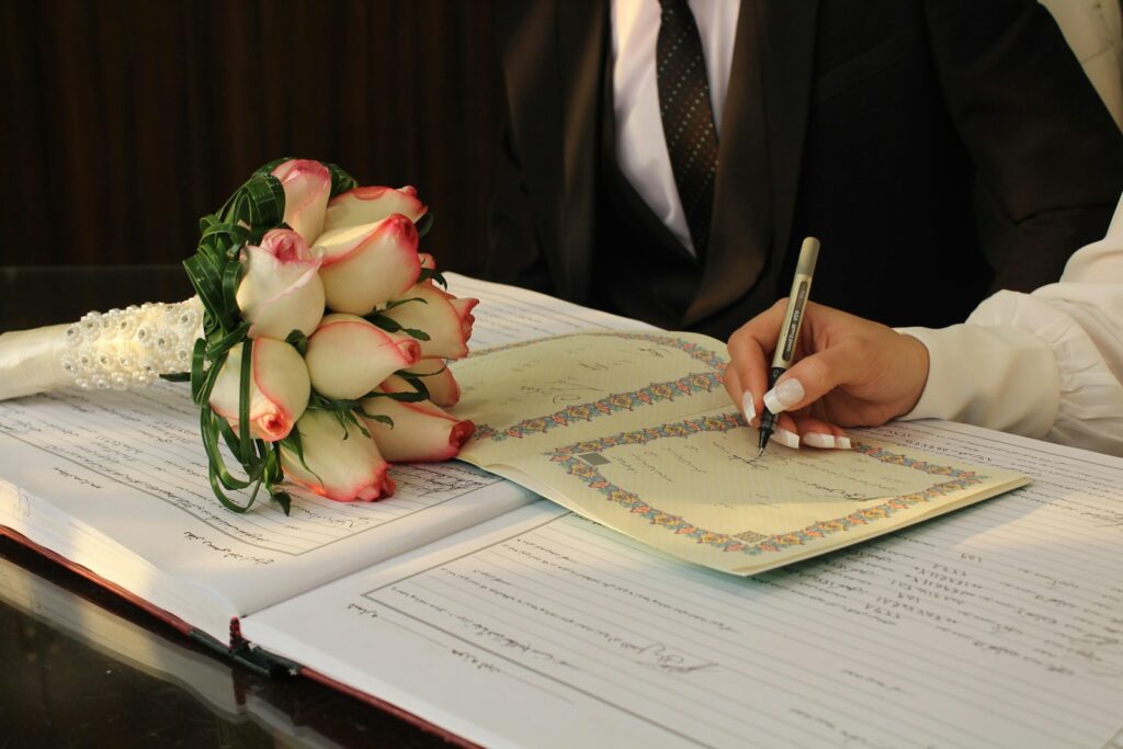 A man in a suit writing on a piece of paper