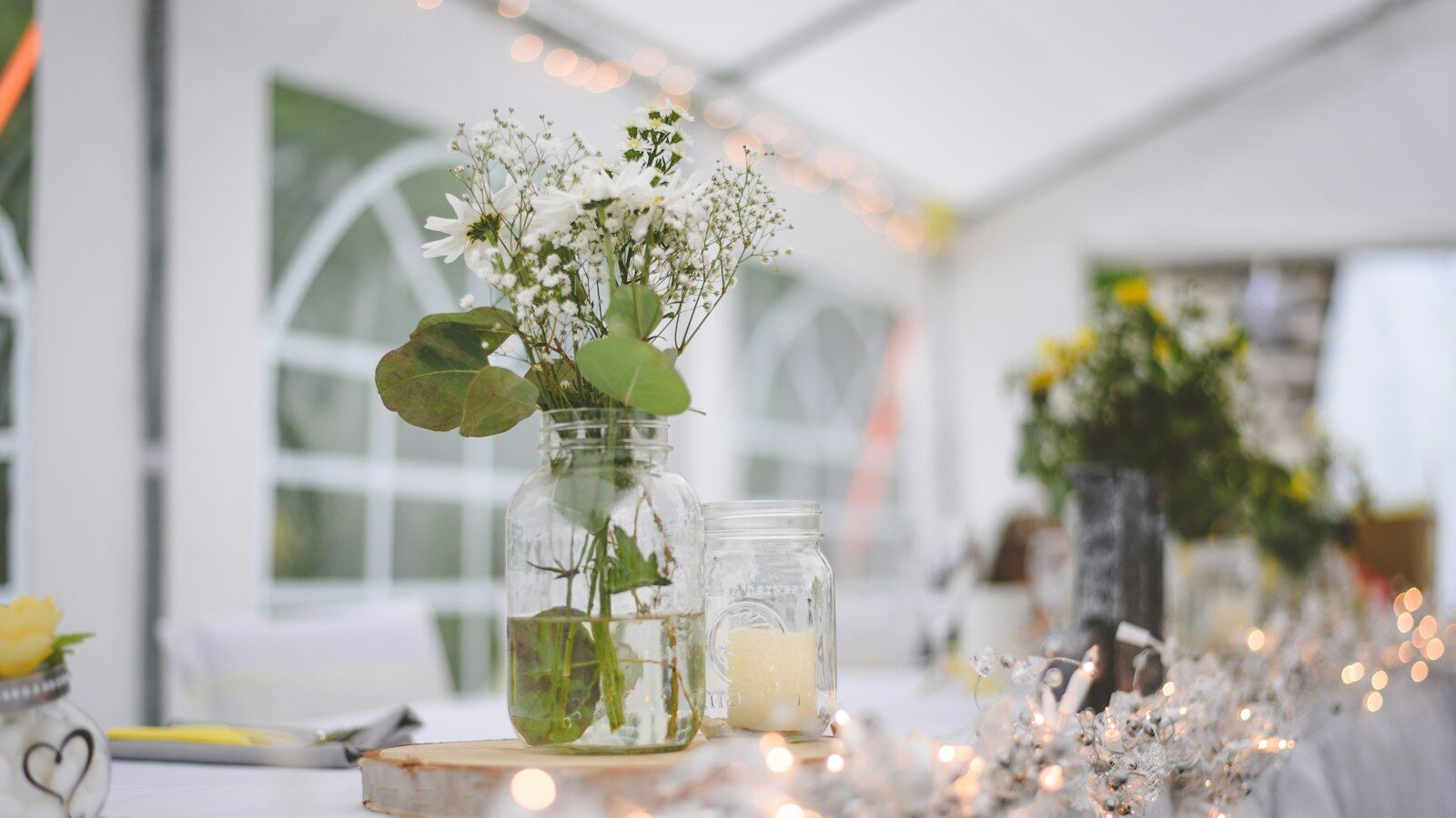 white flowers in clear glass vase on table