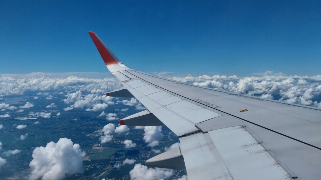 the wing of an airplane flying above the clouds