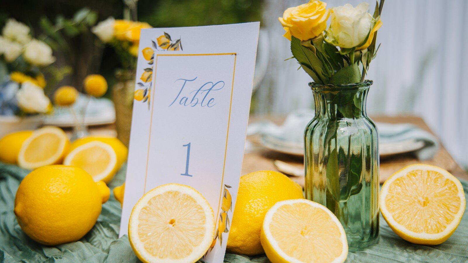 Table setting with lemons and yellow flowers