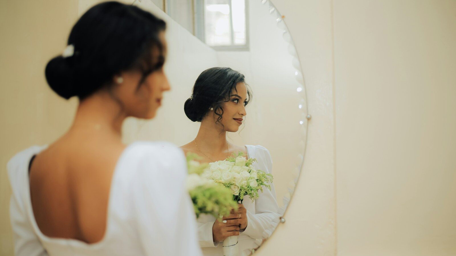 a person standing in front of a mirror posing for the camera