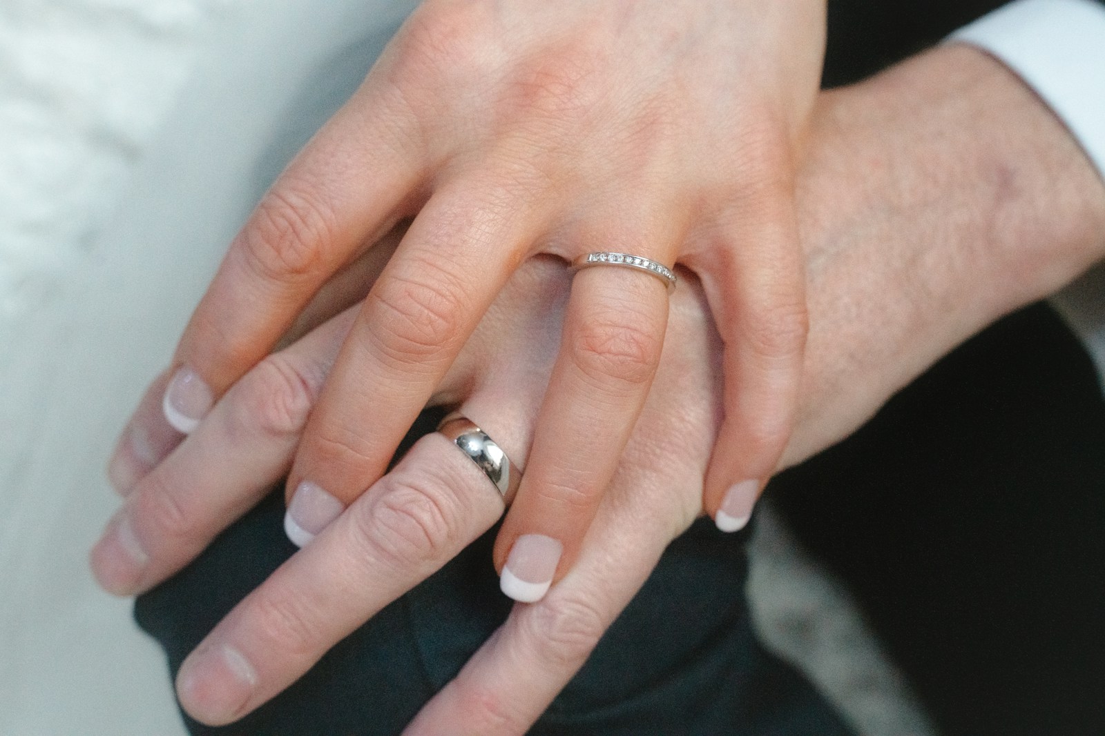 a close up of a person wearing a wedding ring
