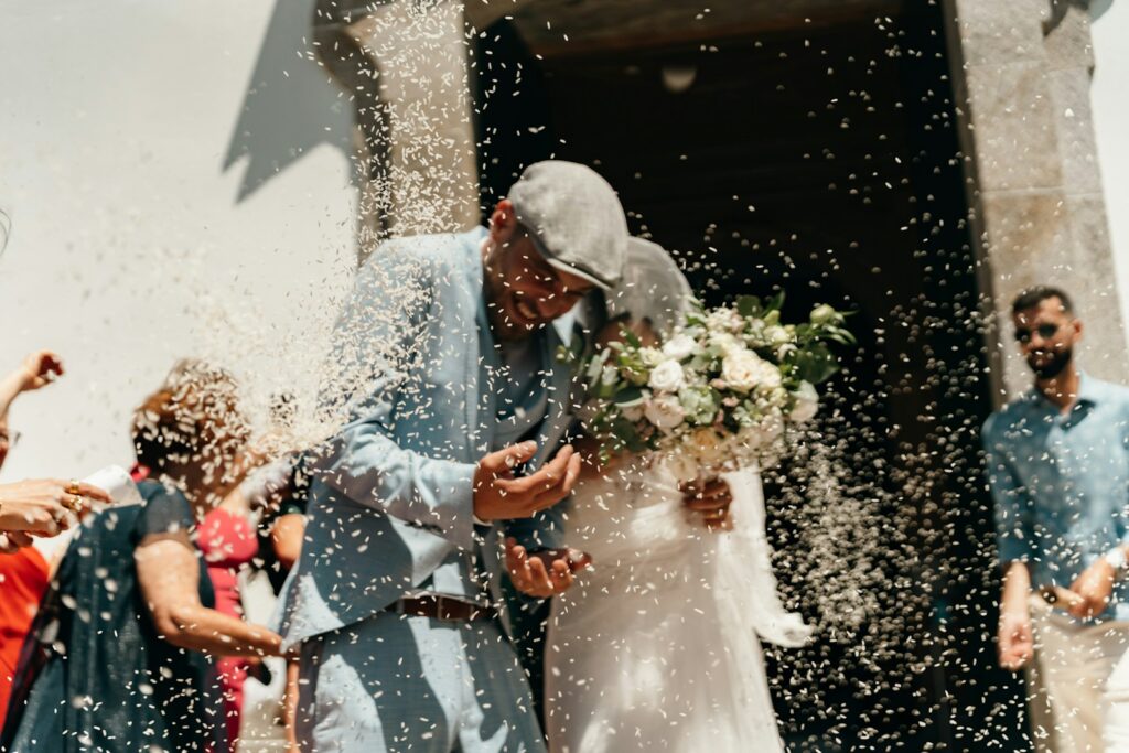Newlyweds showered with confetti outside church.
