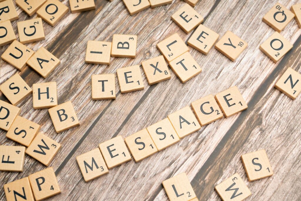 a close up of scrabble letters on a wooden surface